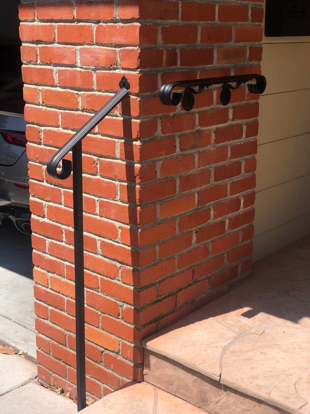 Wrought iron door handrail with wall-mounted handrail